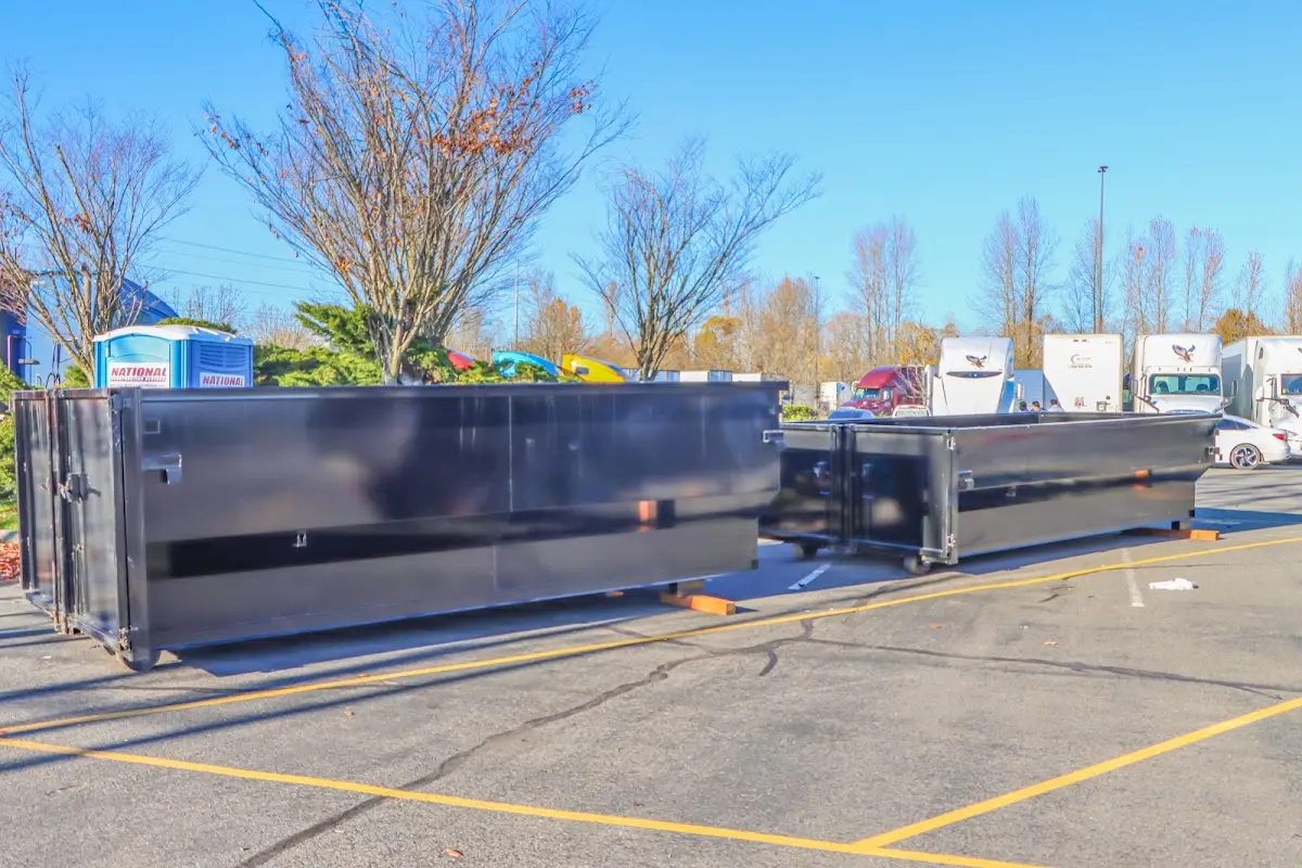Professional dumpster rental service with roll-off container on residential driveway in Placentia